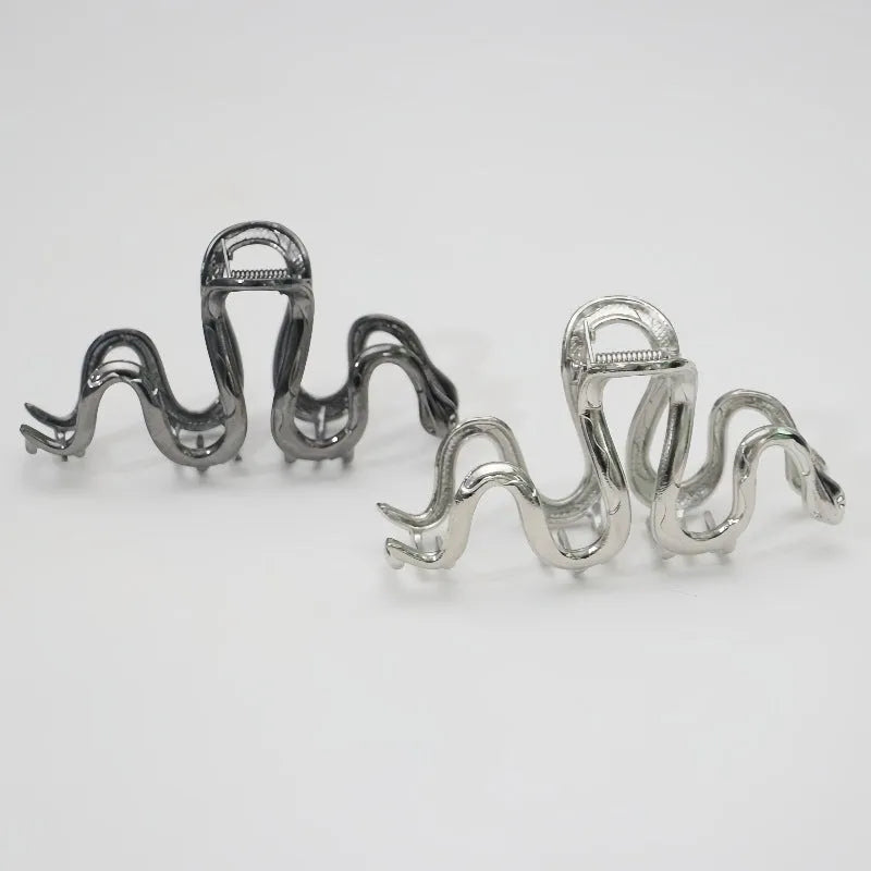 Slytherin serpentine metal hair clip in silver, 10.5cm, on flat surface
