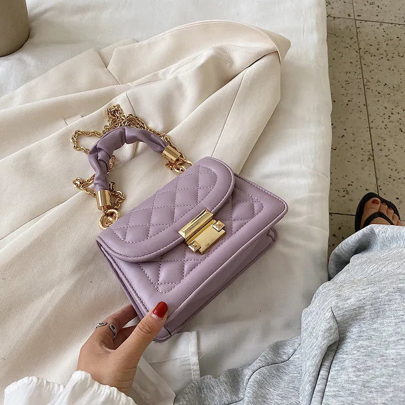 Purple women's small square shoulder bag with crossbody strap showing tapered 16x19cm design