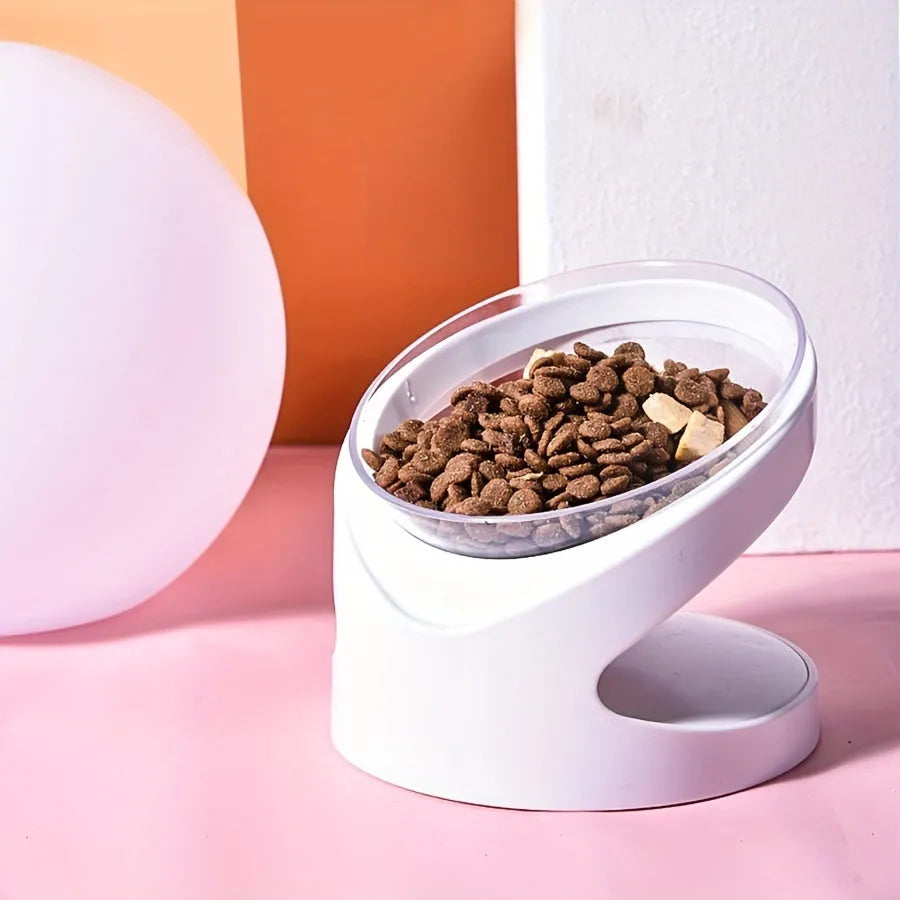 Clear plastic elevated cat food bowl with 15-degree tilt angle on white background