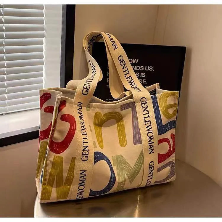 Canvas women's travel tote shopping bag in large capacity format with printing elements