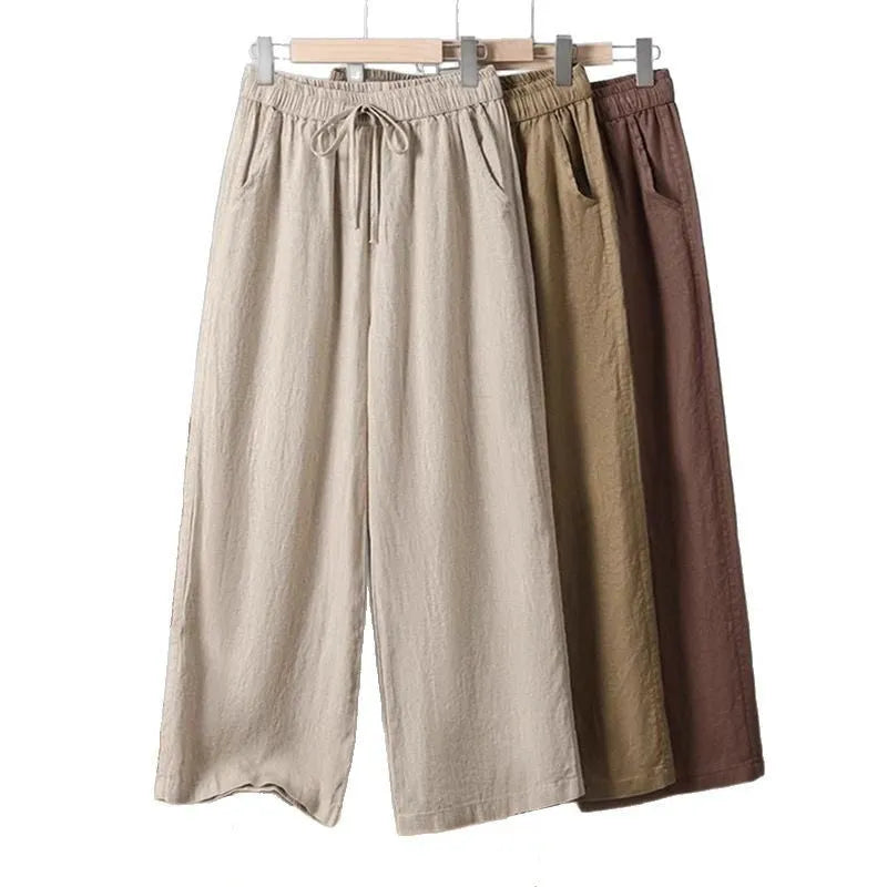 Women's apricot straight-leg casual trousers with a drawstring elastic waistband laid flat.