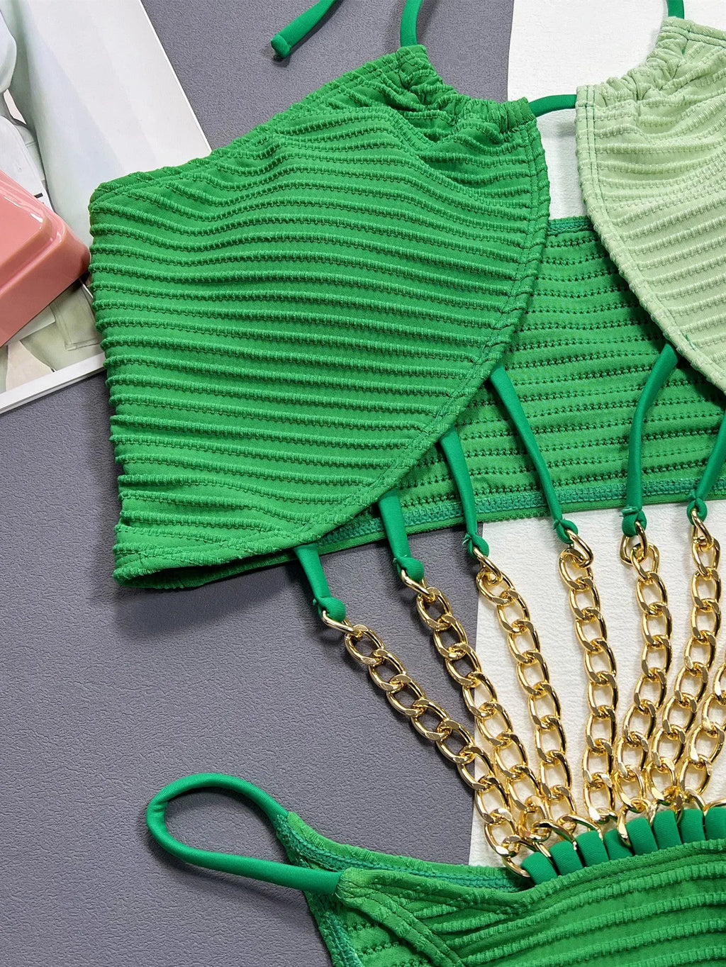Green one-piece swimsuit for women with a hollow cut-out design on the front.