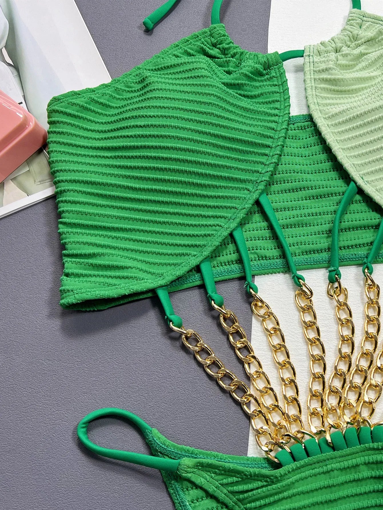 Green one-piece swimsuit for women with a hollow cut-out design on the front.