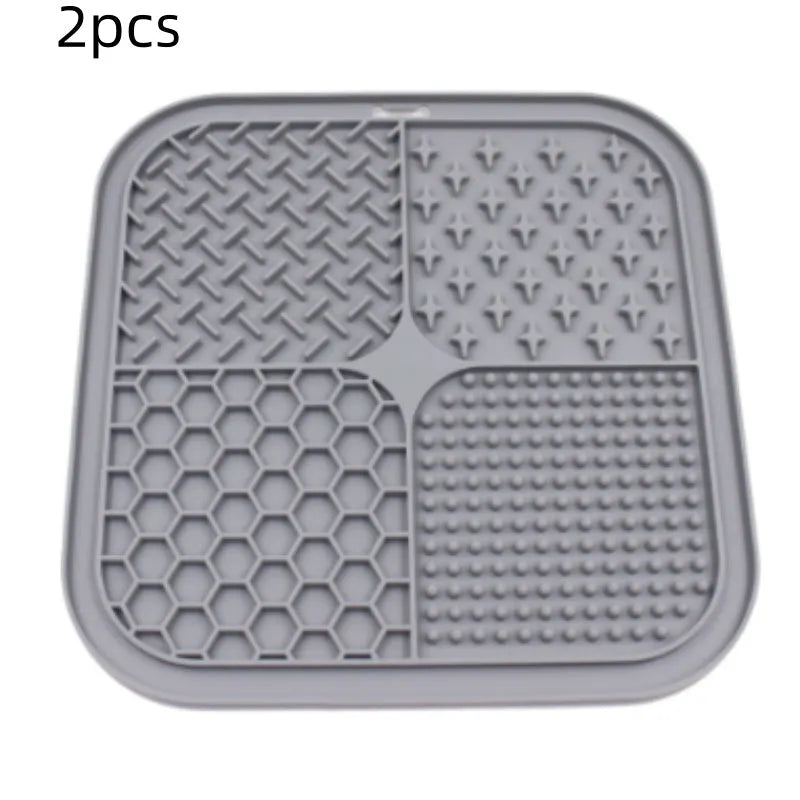 Green silicone pet licking pad 20x20cm with suction cup base on a tiled floor