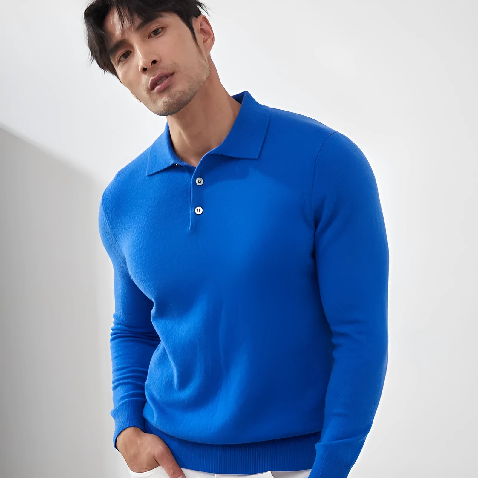 Man wearing a sapphire blue loose-fit cashmere polo neck pullover sweater