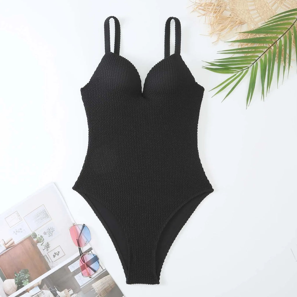 Women's black one-piece swimsuit with sunken stripe pattern and sleeveless design