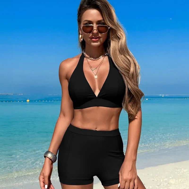 Women's black split bikini swimsuit on a hanger.