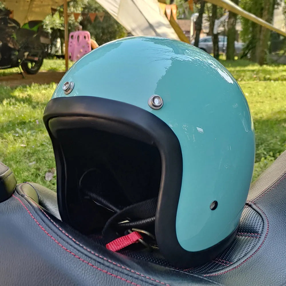 Retro-style open-face motorcycle helmet in glass fibre construction shown in a cement grey colour.