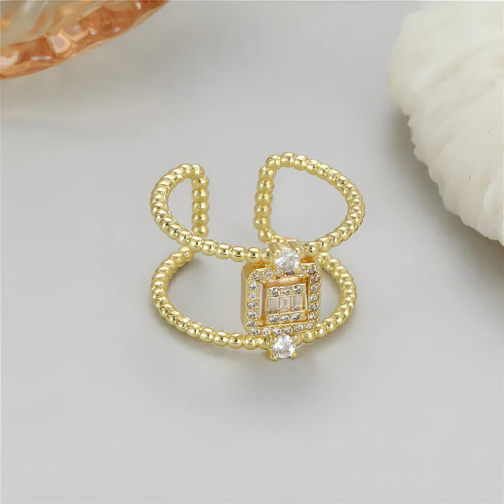 Gold tone adjustable open ring with U-shaped design and asymmetrical silhouette