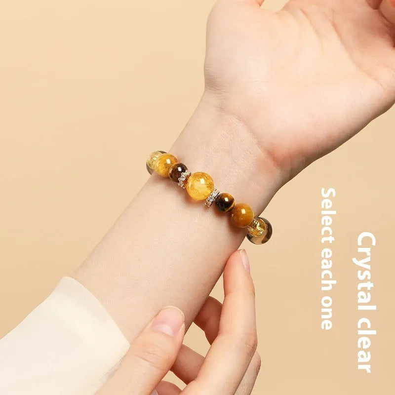Natural tiger-eye crystal bracelet with geometric beads in either 10mm or 12mm size on a wrist.