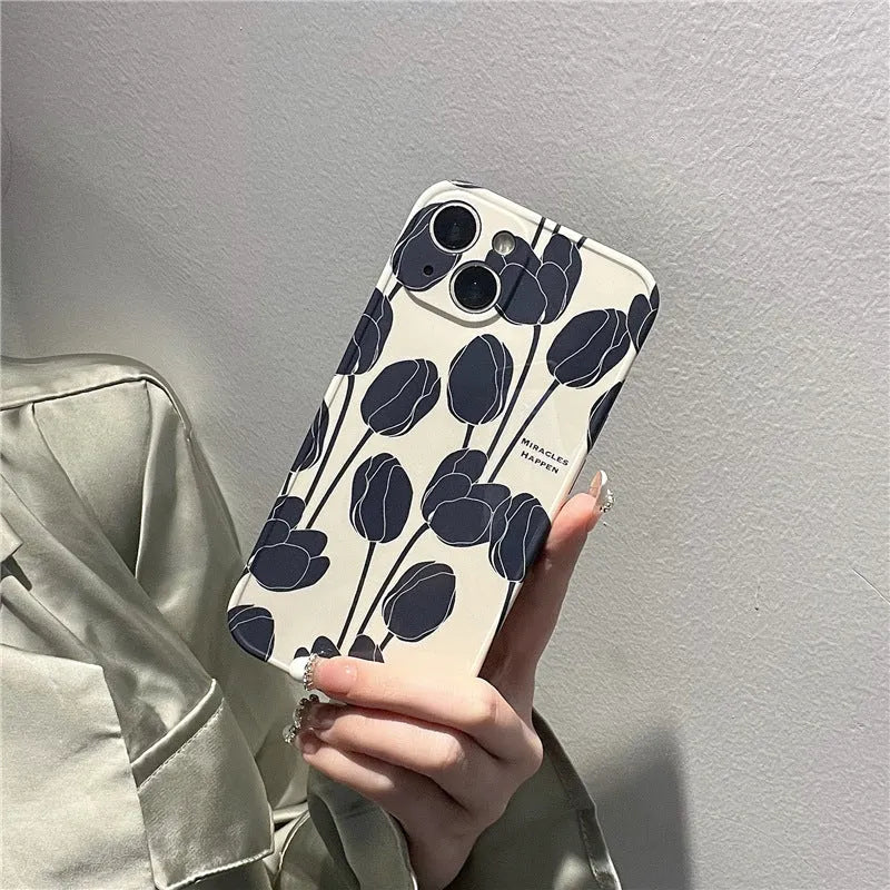 Black silicone iPhone case with a white tulip floral graphic on the back