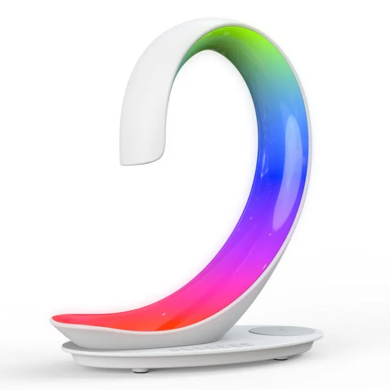 White swan-shaped desk lamp with wireless charging pad and Bluetooth speaker, showing colourful LED lights.