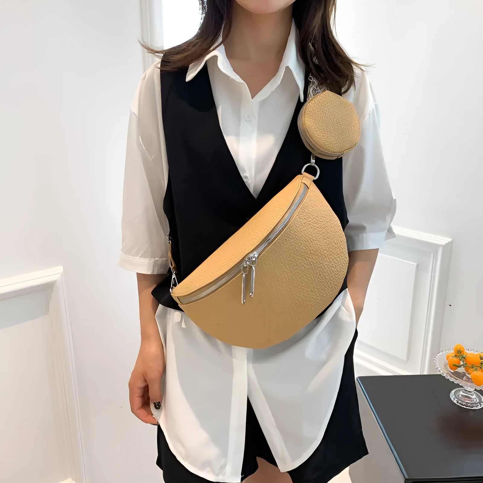 Solid colour PU crossbody bag with saddle lock zipper and sewing thread detail, beige colour, front view
