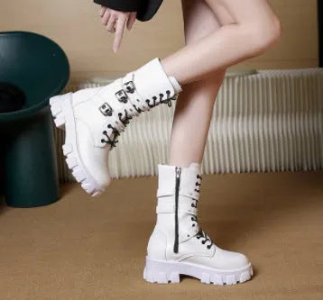 Women's black knee-high boots with metal buckle straps and a side zipper closure.