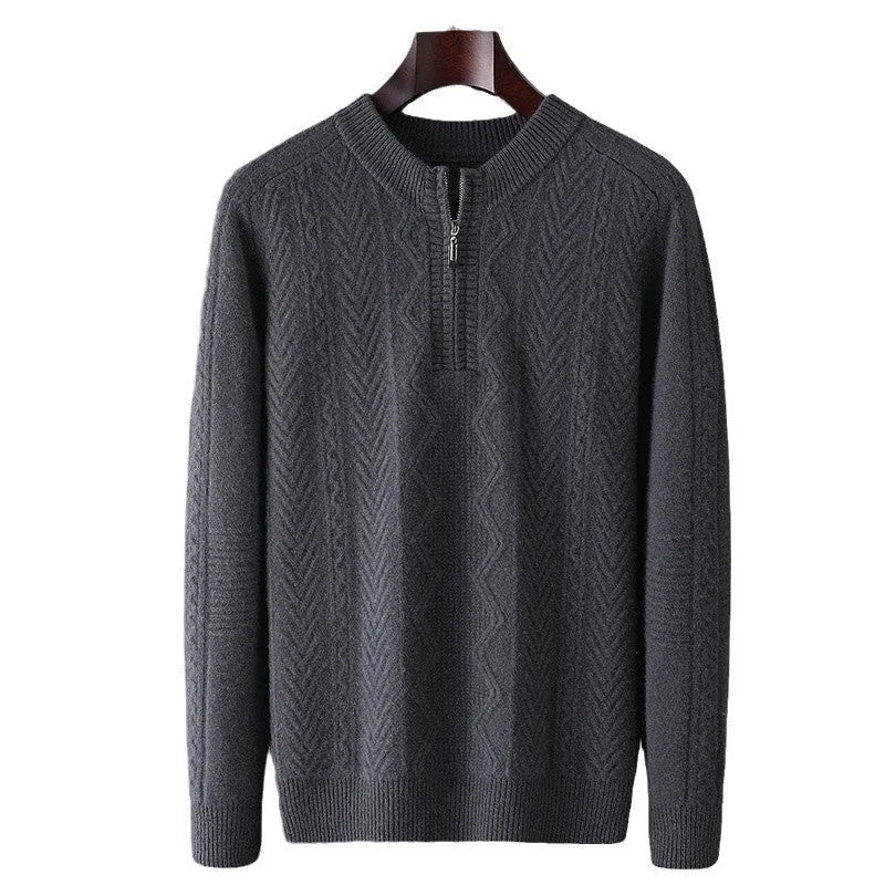 Man wearing a loose-fit, light-coloured wool sweater with a diamond lattice pattern and a half-zip front.