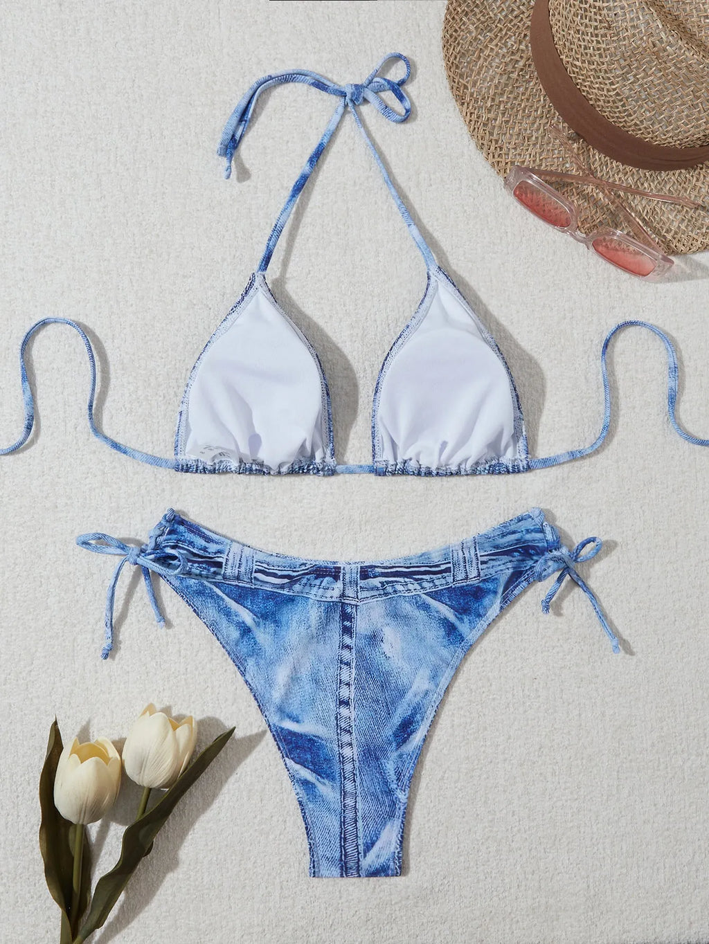 Denim blue printed women's bikini set with strappy triangle top and matching bottoms on a neutral background.