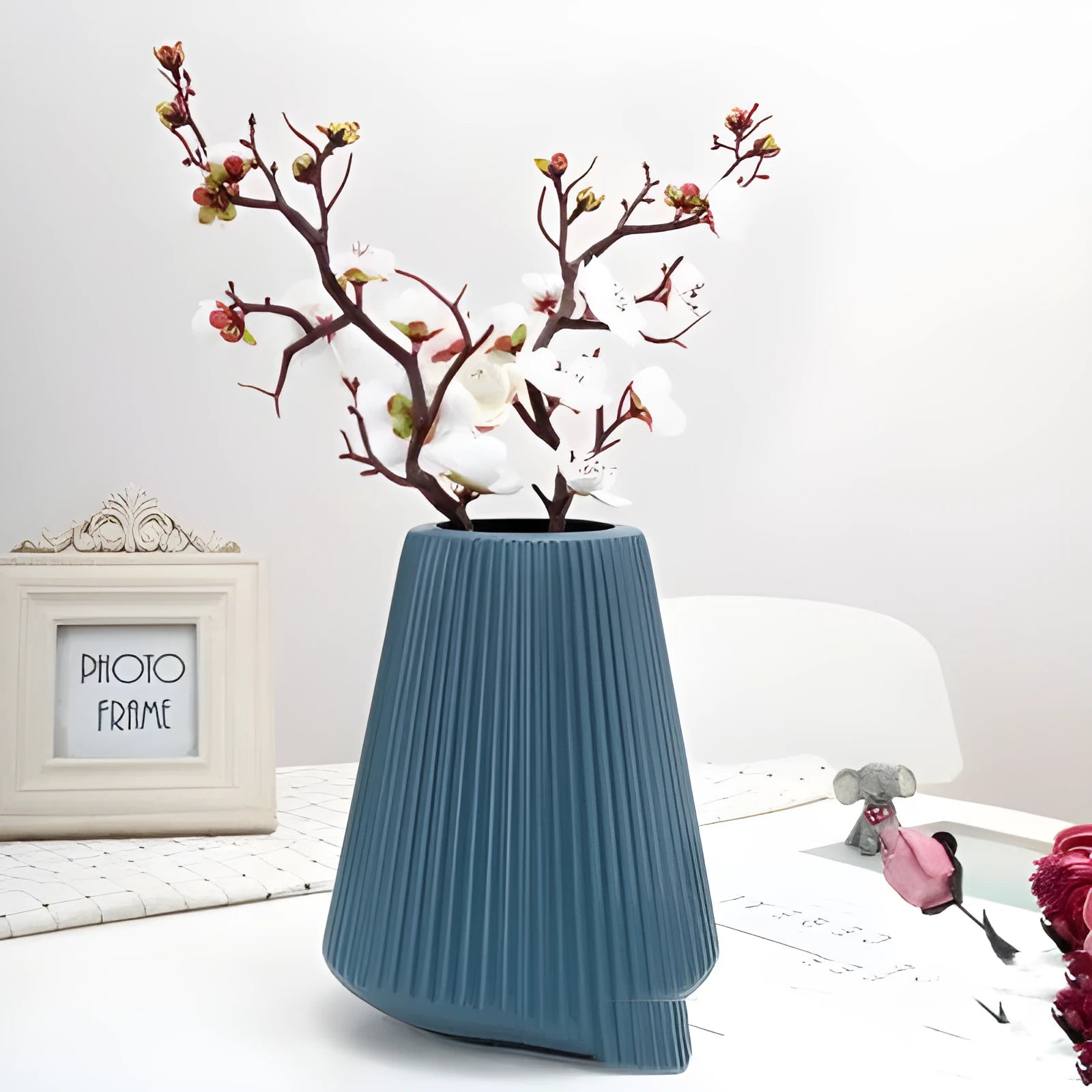 Colourful melamine plastic decorative flower vase on a desktop, 16cm wide by 20cm tall.