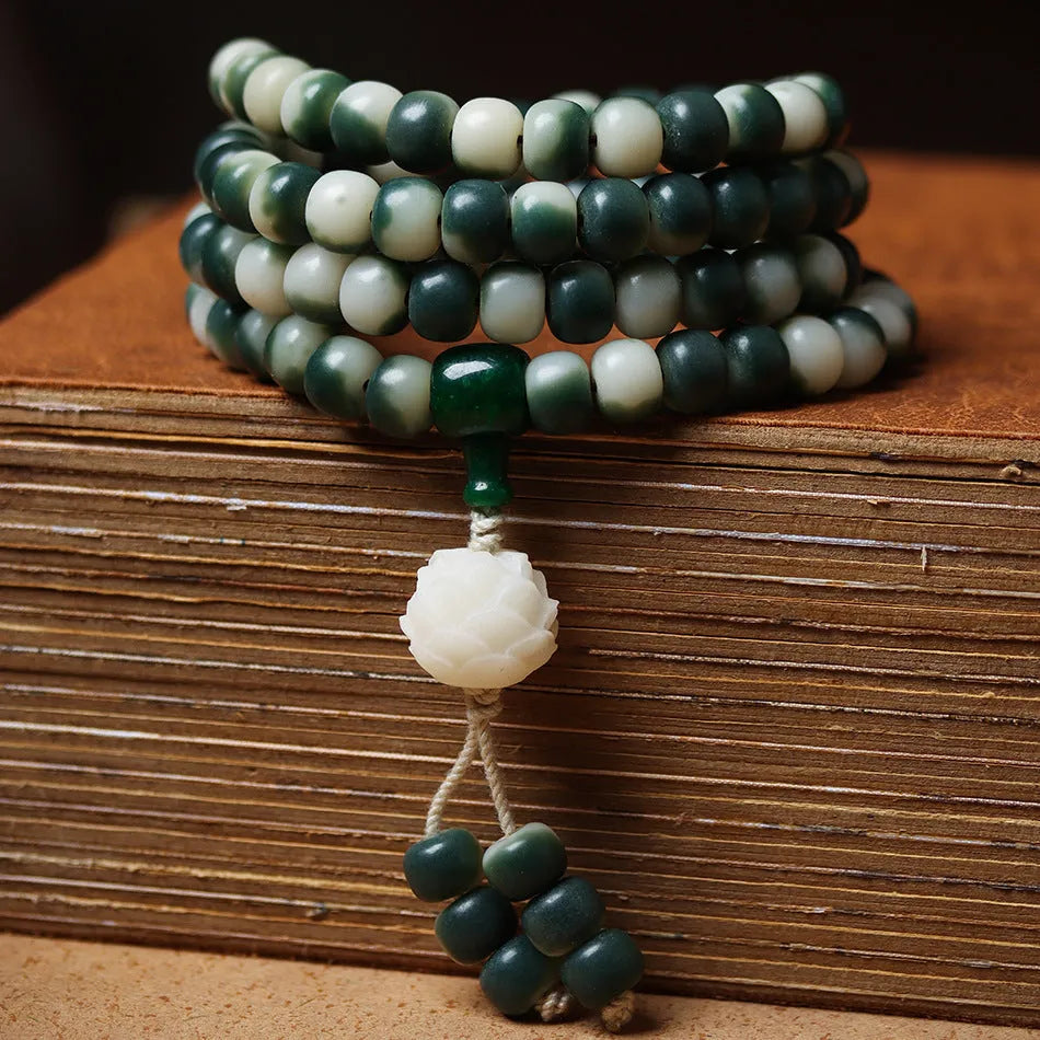 Lotus White Jade Bodhi Beads Bracelet with 8x10mm floating flowers beads on a neutral background