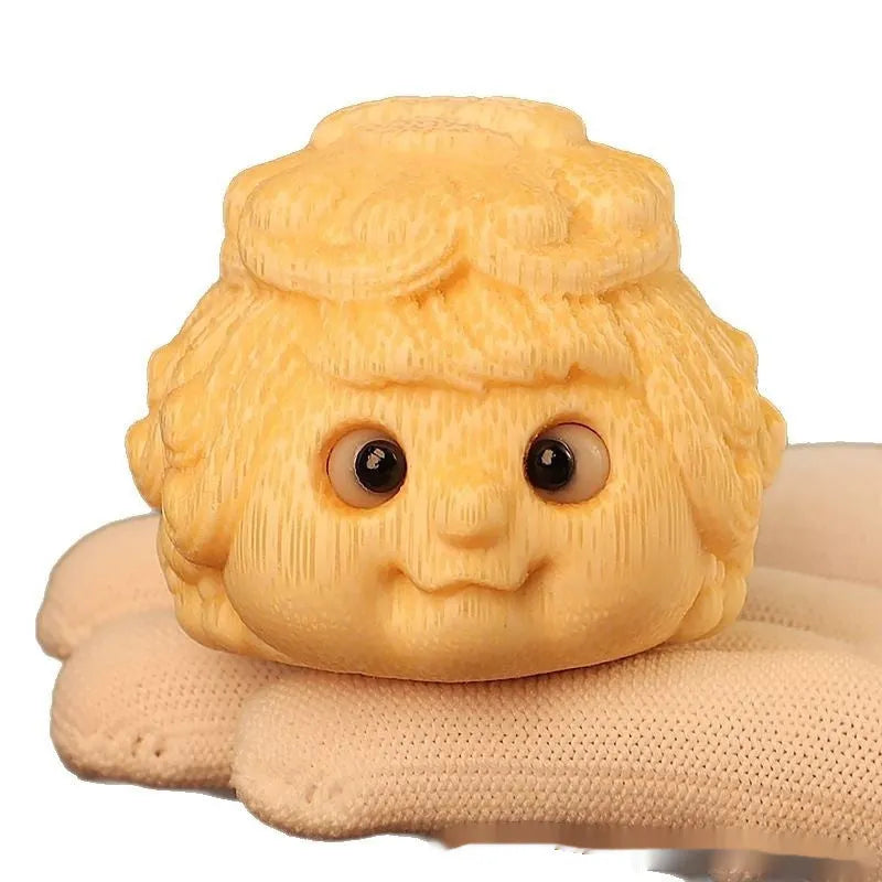 Solid bamboo carving of a cute Golden Toad Princess ornament on a white background.