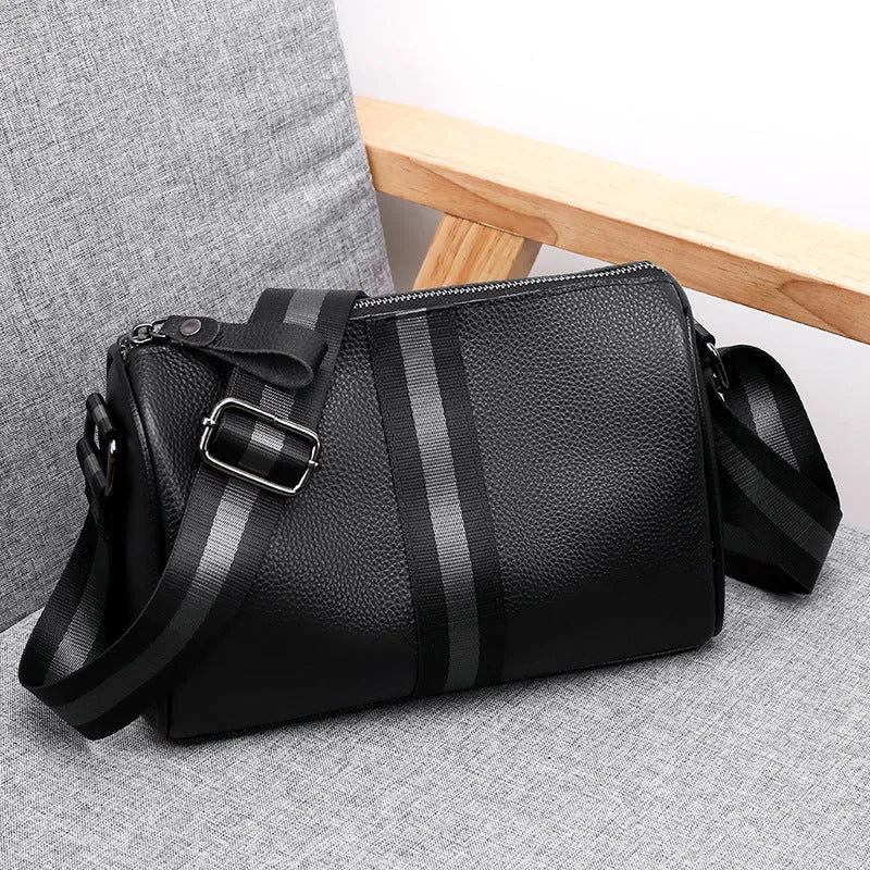 Black genuine leather one-shoulder crossbody bag showing front and strap.