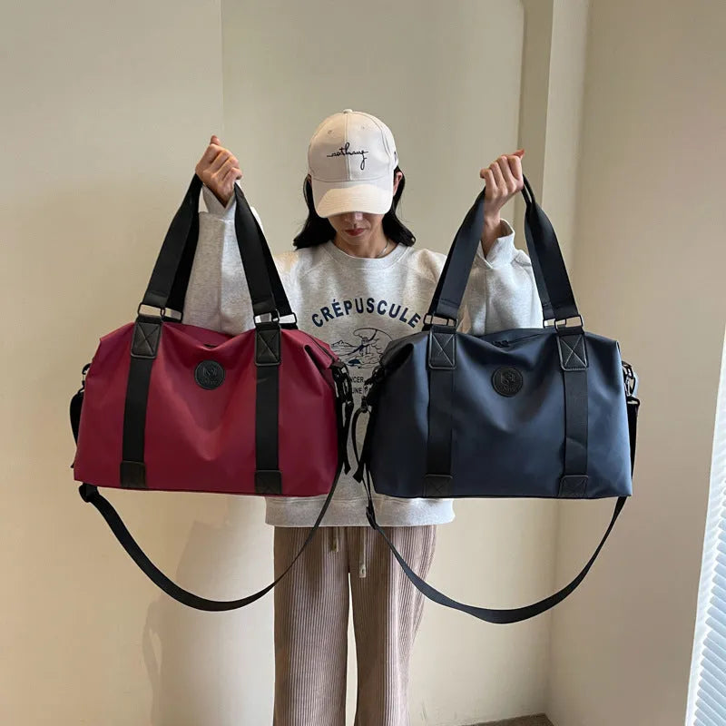 Waterproof Oxford cloth travel bag in black, blue, grey or red with 36-55 litre capacity