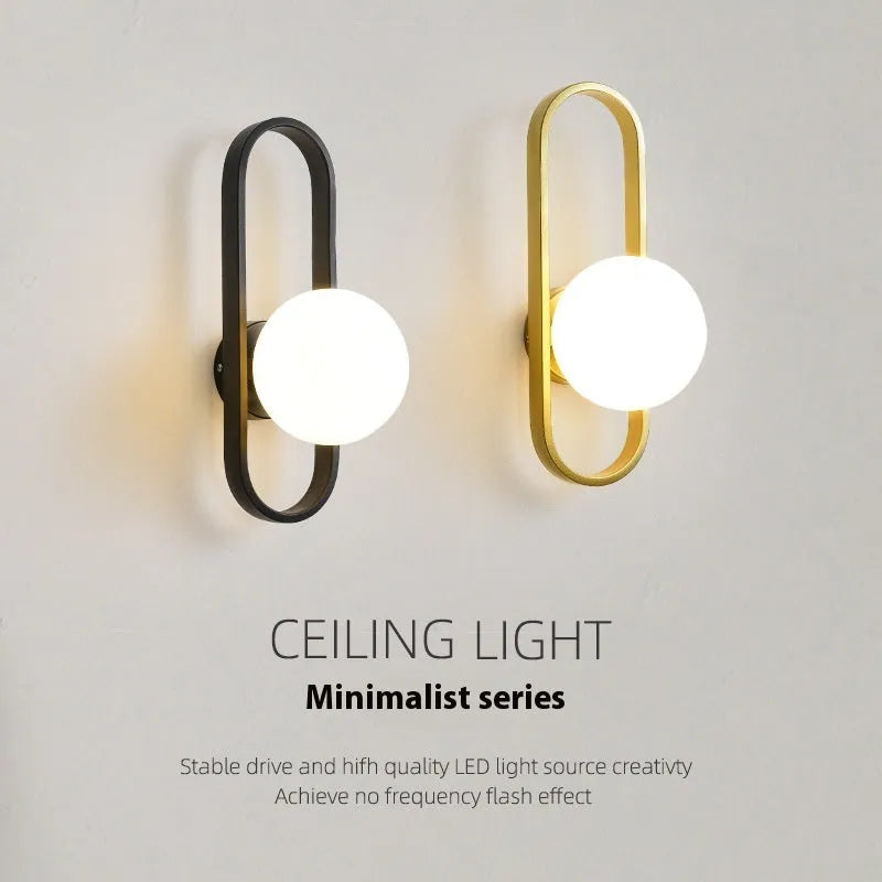 Minimalist modern wall lamp with iron body and glass shade in black or gold finish.