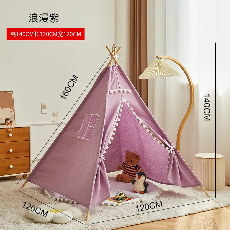 Children's indoor princess castle play tent with wooden frame, in a pink fur ball style with an open front and decorative top