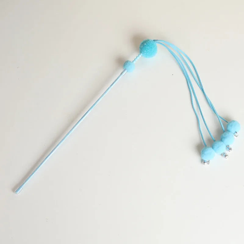 Pipitao funny cat stick toy with blue tassel on a carpet for pet play
