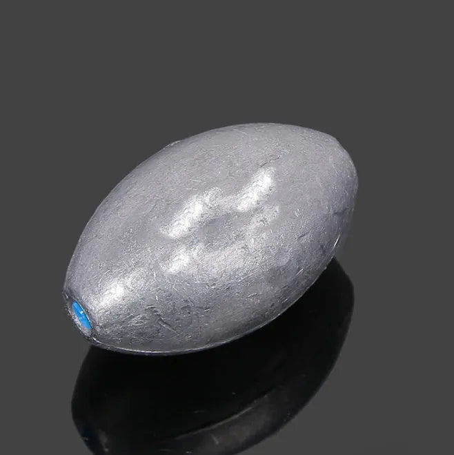 Olive-shaped sea fishing lead sinker with scale pattern texture and plastic core