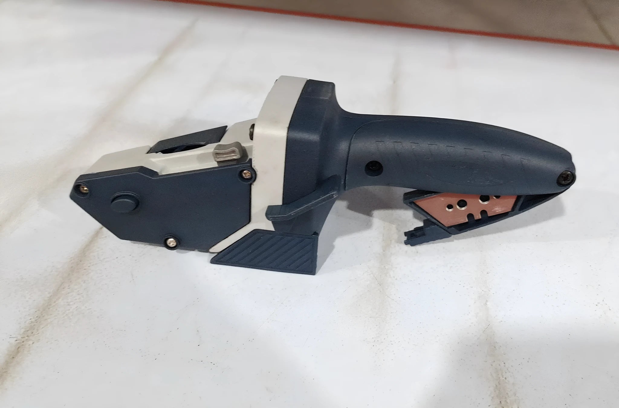 Blue multifunctional woodworking cutter with a measuring scale and one-press lock for dust-free board cutting.