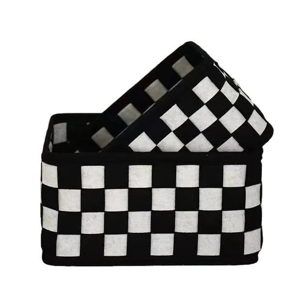 Black and white checkerboard woven felt storage basket with folded sides.