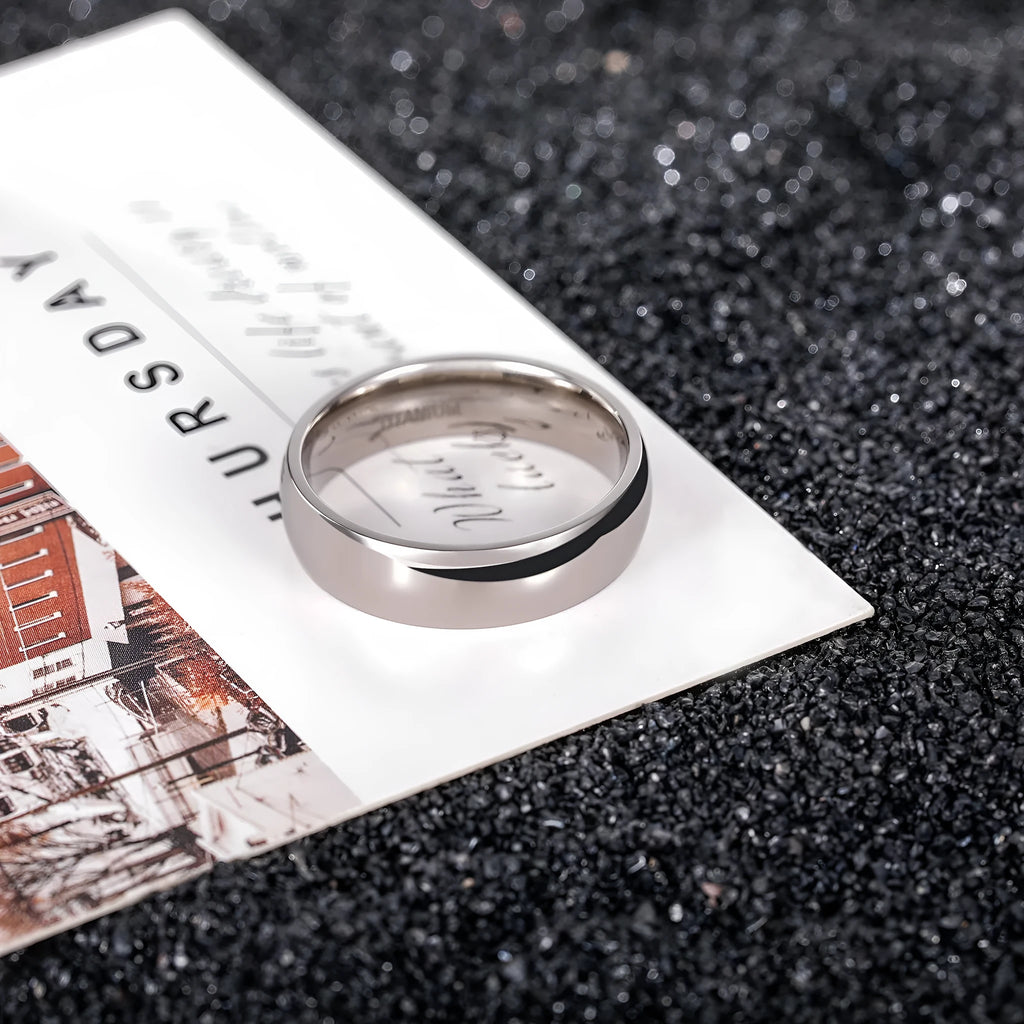 Silver pure titanium ring showing metallic finish and band width options on size guide