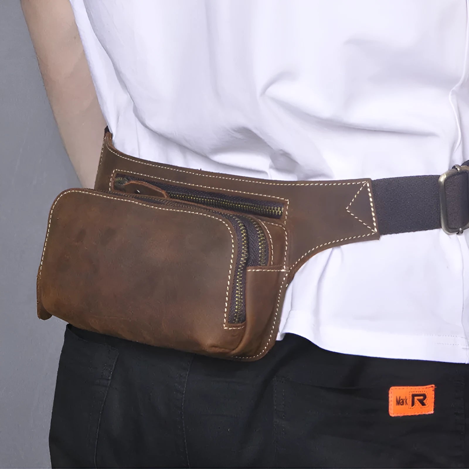 Brown top layer cow leather men's sports waist bag with a zip closure.