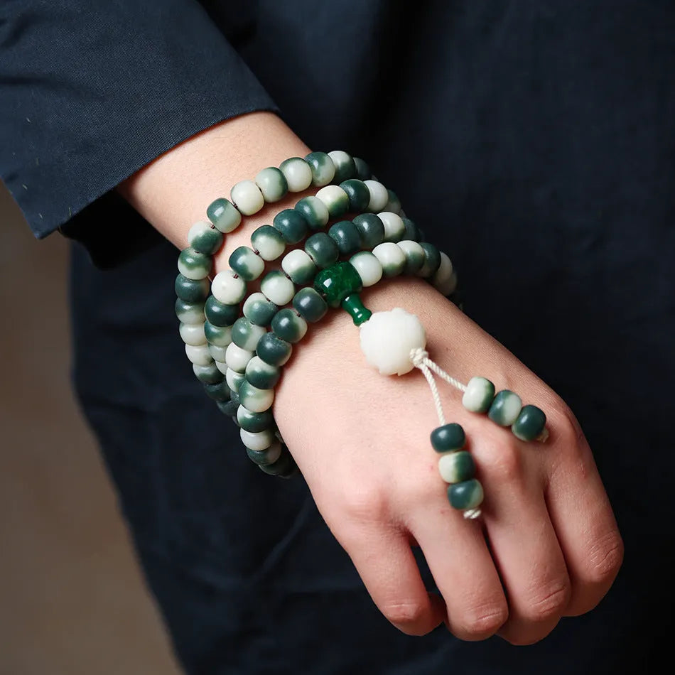 Lotus White Jade Bodhi Beads Bracelet with 8x10mm floating flowers beads on a neutral background