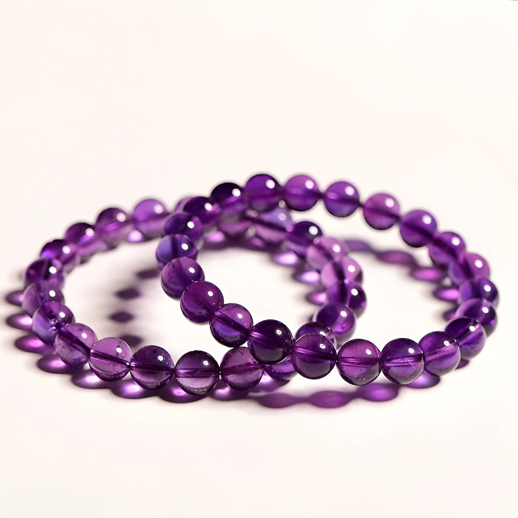 Natural Uruguayan amethyst scattered beads bracelet in various grades and sizes on a white background.