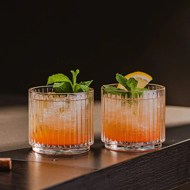 Clear glass cup and pot set with striped and diamond pattern designs for whiskey or wine