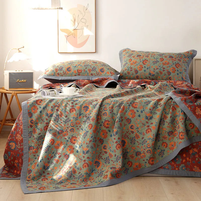 Three-piece cotton gauze bed blanket set with floral pattern showing blanket and two pillowcases