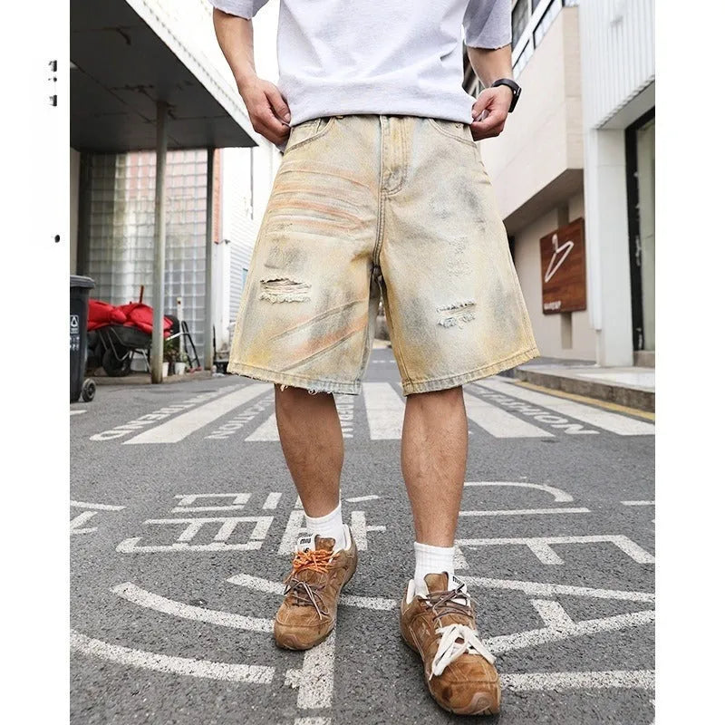 Men's light blue washed ripped straight-leg denim shorts on model front view