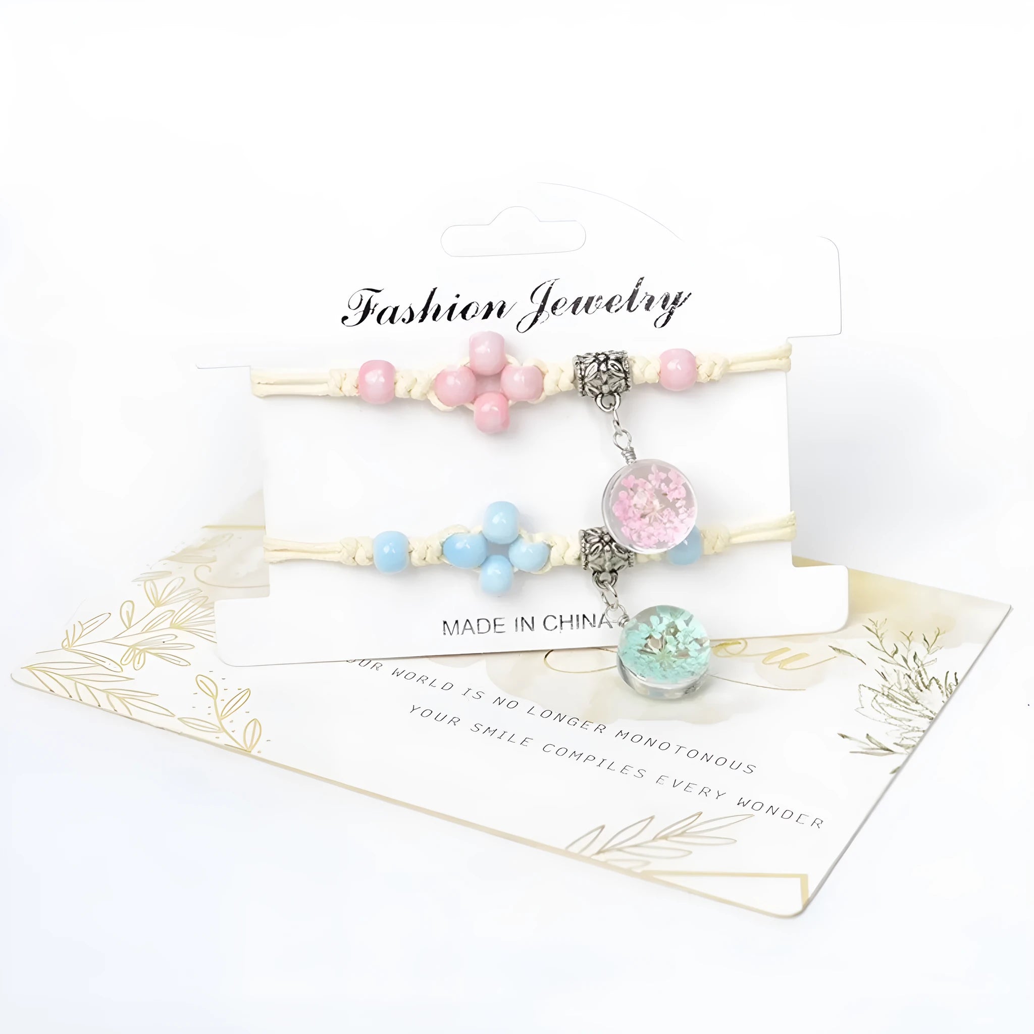 Close-up of a women's glass bracelet with large 1.4cm beads containing dried flowers and a hand-woven lace pattern.