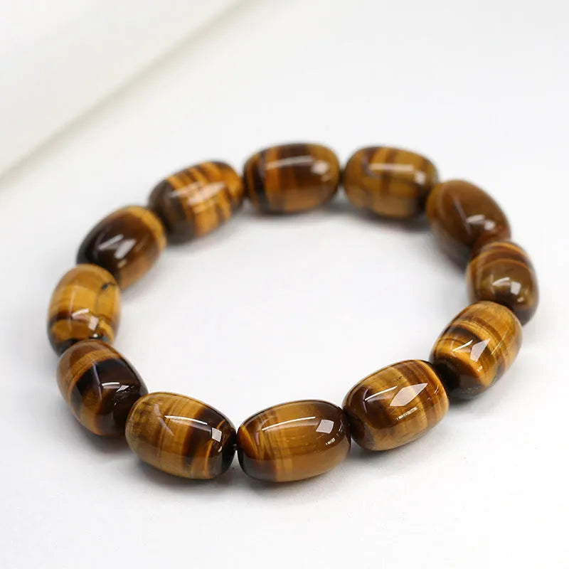 Natural yellow tigereye bracelet with cat eye sheen, 11x16mm beads, unisex constellation style on white background