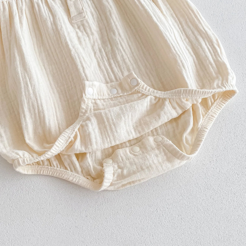 Summer cotton baby jumpsuit in apricot with double-breasted closure and matching hair band