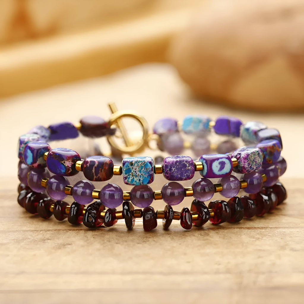 Amethyst round beads stone bracelet with purple garnet and geometric texture on plain background