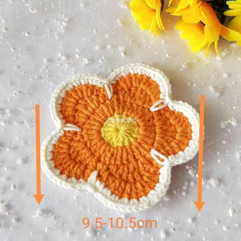 Handmade cotton thread woven flower coaster set of 5 in blue, green, orange, pink, purple on a table