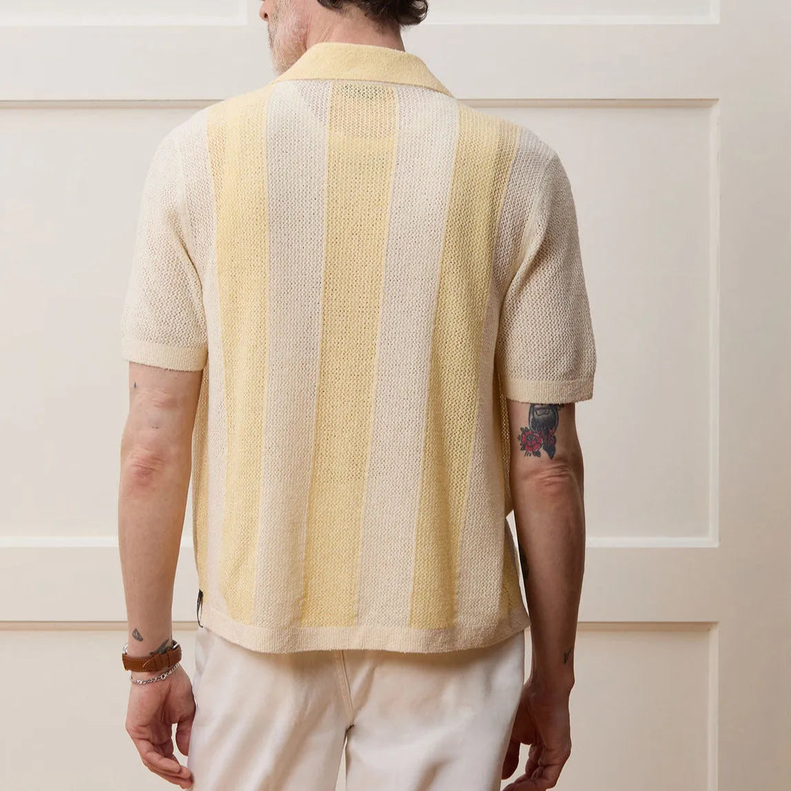 Yellow men's short-sleeve polo shirt with hollow-out design and asymmetric cut.