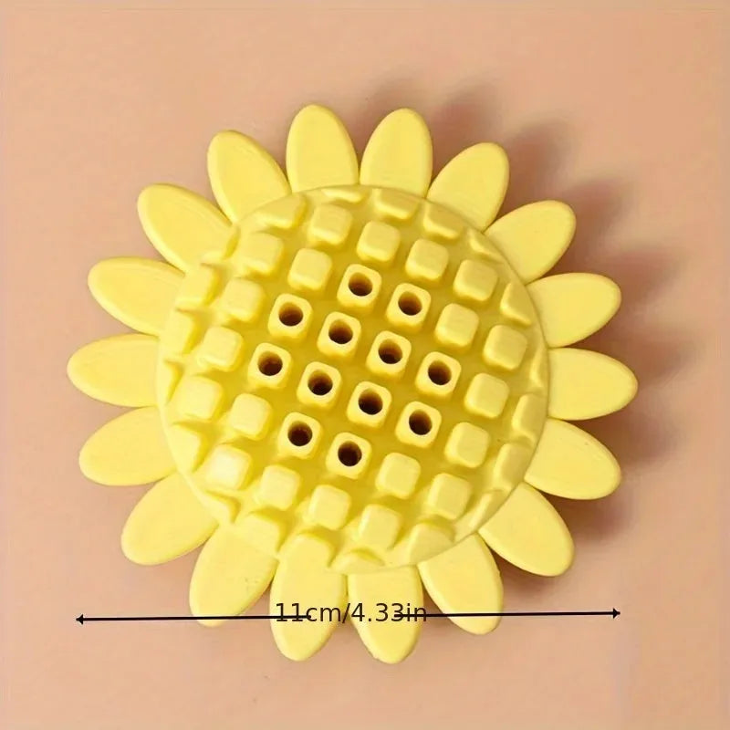 Yellow rubber sunflower dog toy for teething puppies on a light background