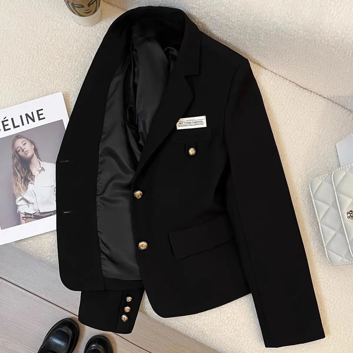 Women's black polyester short suit coat with loose fit and hip-length design