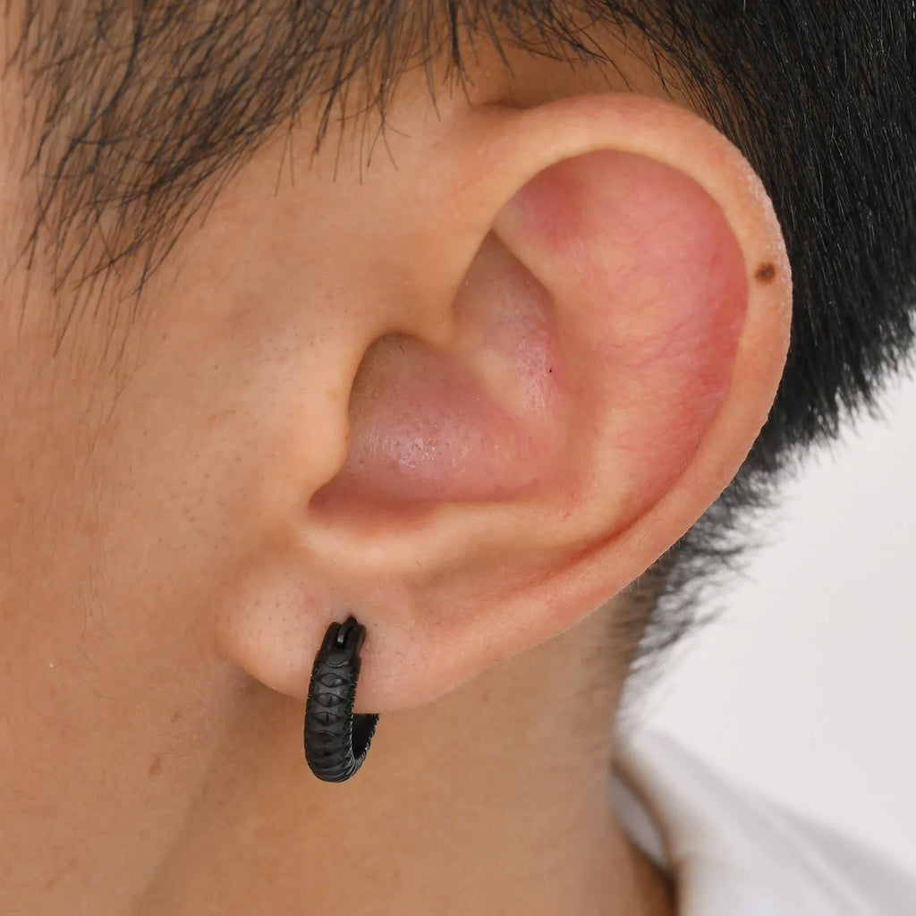A pair of stainless steel snake pattern earrings in black or gold hip hop style.