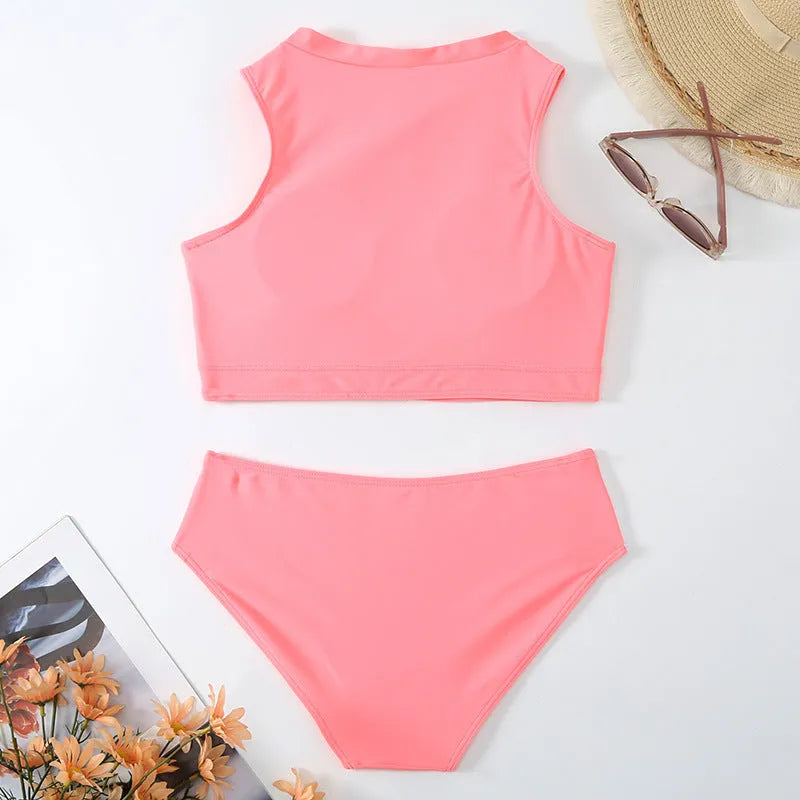Pink high-waist bikini swimsuit with briefs style shorts and sleeveless top on a neutral background.