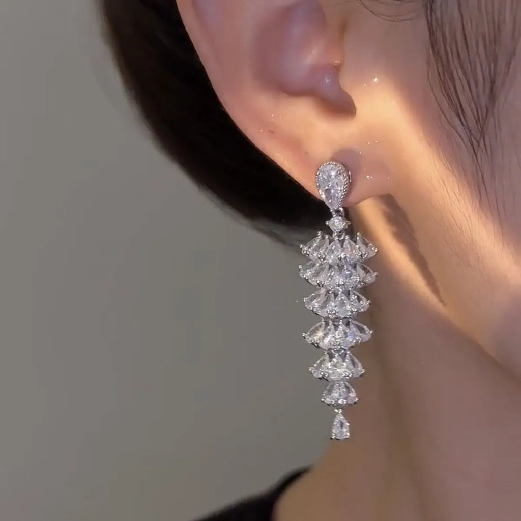 Pair of silver-coloured Christmas tree drop earrings with pagoda shape on stud fastenings.