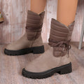 Women's black chunky heel snow boot with lace-up design and suede upper on a white background.